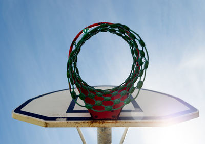 Low angle view of basketball hoop against sky on sunny day