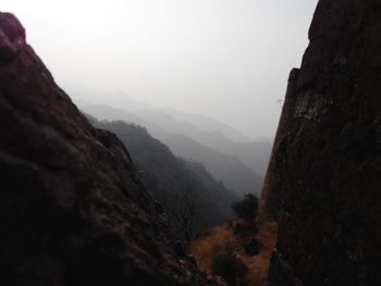 Scenic view of mountains against cloudy sky