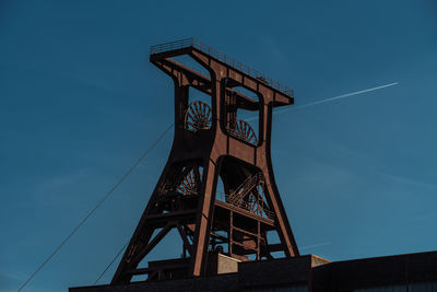 Low angle view of tower bridge against blue sky