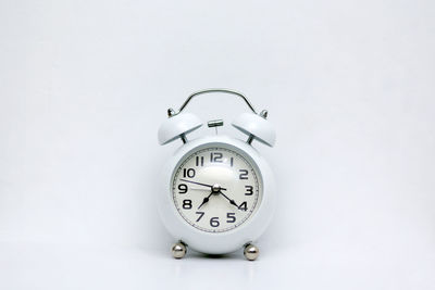 Close-up of clock on white background