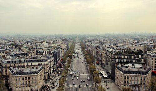 High angle view of vehicles on road amidst buildings in city