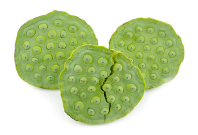 Close-up of heart shape leaf against white background