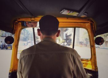 Rear view of man in bus