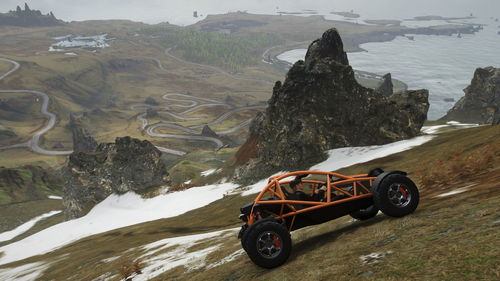 Vintage car on rocks by land