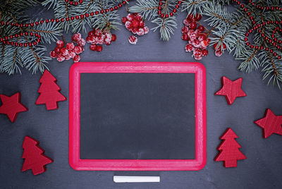 Directly above shot of black board surrounded with christmas decorations