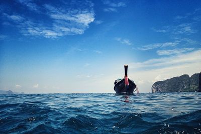 Boat in sea against blue sky