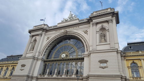 Low angle view of building against cloudy sky