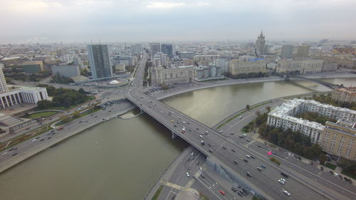 Aerial view of bridge over river against sky in city