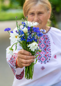 Midsection of woman holding bouquet