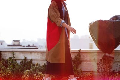 Woman standing by railing