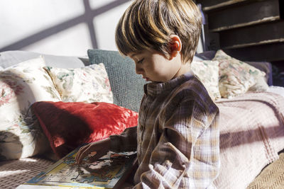 Boy playing puzzle game at home