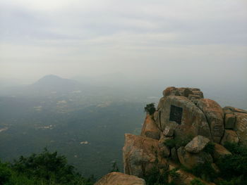 Castle on mountain against cloudy sky