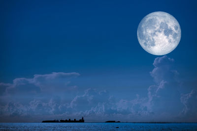 View of sea against moon in sky