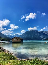 Scenic view of lake and mountains against sky