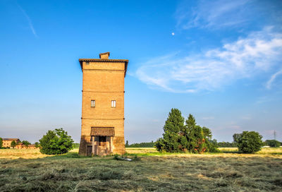 Built structure on field against sky