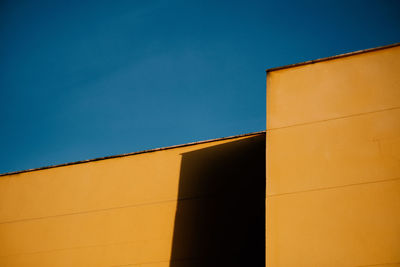 Low angle view of building against blue sky