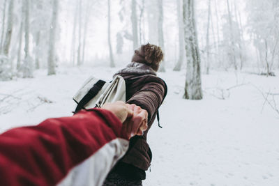 Rear view of woman on snow covered landscape