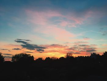 Silhouette trees against sky during sunset