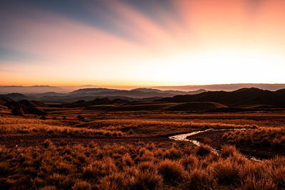 Scenic view of field against sky during sunset