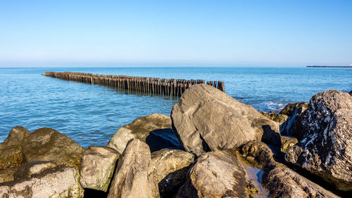 Scenic view of sea against clear blue sky