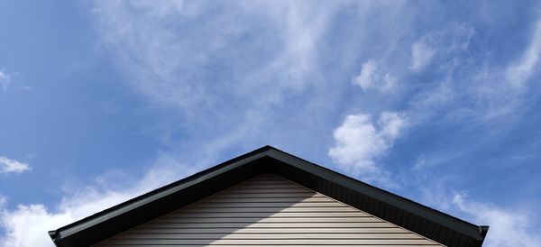 Low angle view of building against cloudy sky