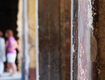 People standing by wall of building