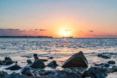 Close-up of sea against sky during sunset