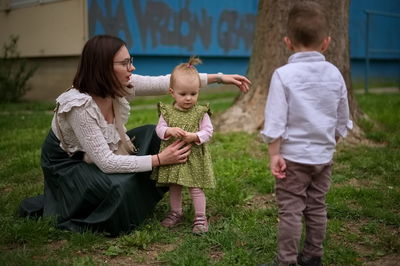 Mother and little children standing in the park