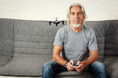 Portrait of smiling man sitting on sofa