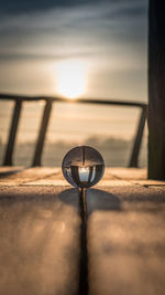 Close-up of table against sky at sunset