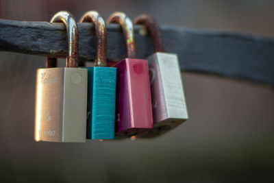 Close-up of padlocks hanging on metal