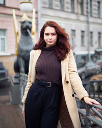 Portrait of woman standing in city