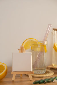 Empty painting canvas for you text mock up copy space glass of water with fresh lemon juice with