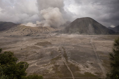 Scenic view of mountains against cloudy sky