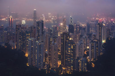 Aerial view of illuminated buildings in city at night