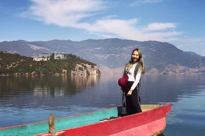 Woman on lake against mountains