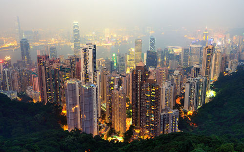 High angle view of illuminated cityscape against sky at night