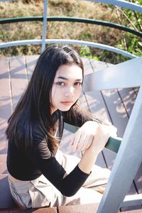 Portrait of young woman sitting outdoors