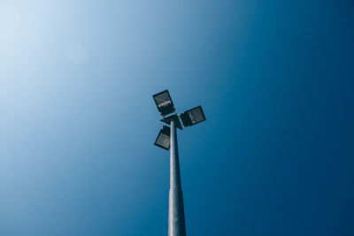 Low angle view of windmill against clear blue sky