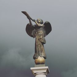 Low angle view of statue against sky