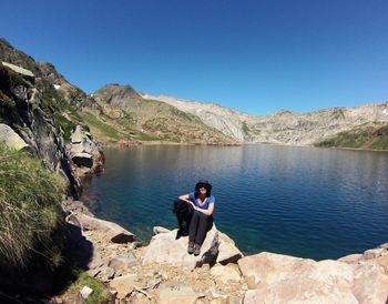 Man in lake against clear sky