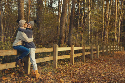 Couple kissing in forest during autumn