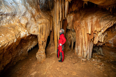 Rear view of woman standing on rock formations