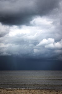 Scenic view of sea against storm clouds