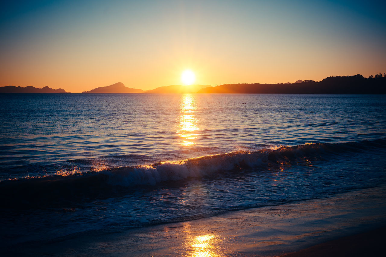 SCENIC VIEW OF SEA AGAINST ORANGE SKY