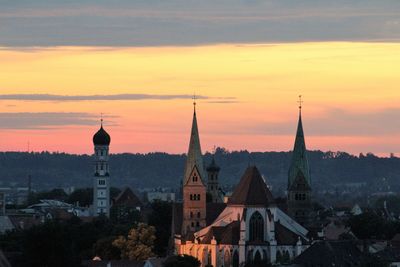 View of buildings in city during sunset