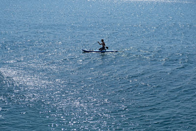 A young sports man with a child sails on a sup in the sea. healthy lifestyle concept