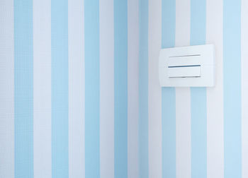 Pastel color of wallpaper and the light switch in a sweet bedroom