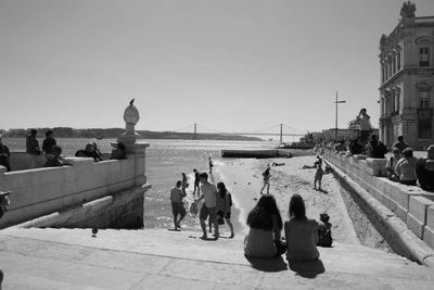 People at observation point against clear sky