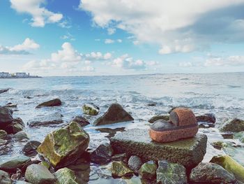 Rocks on beach against sky